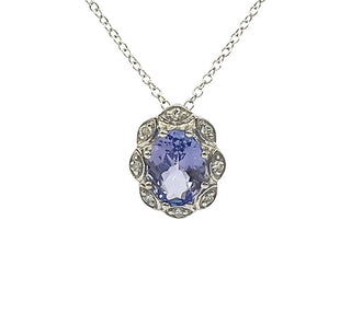 Silver necklace with a purple gemstone pendant on a white background