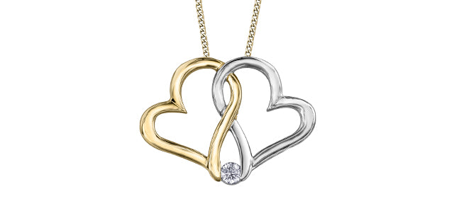 Two-toned heart-shaped pendant necklace with a diamond on a white background
