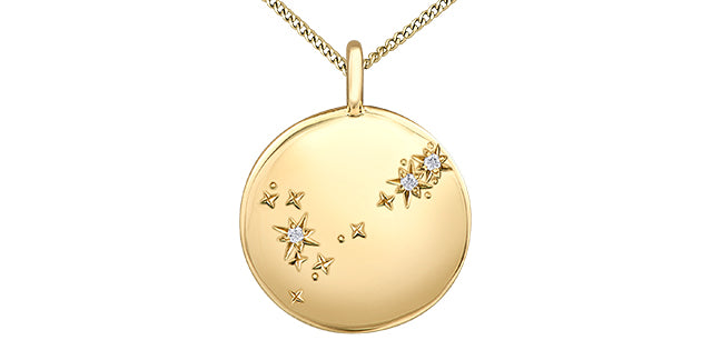 Gold necklace with a circular pendant featuring star designs on a white background