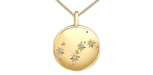Gold necklace with a round pendant featuring star designs on a white background