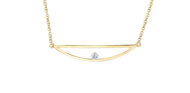 Gold necklace with a heart-shaped diamond pendant on a white background
