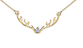 Gold deer antler necklace with a diamond on a white background