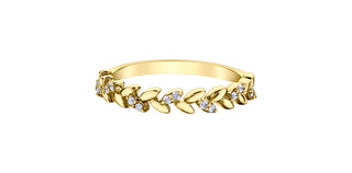 Gold bracelet with leaf design and small stones on a white background