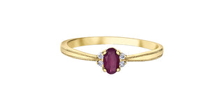 Gold ring with a red gemstone on a white background