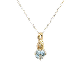 Gold necklace with a heart-shaped blue gemstone pendant on a white background