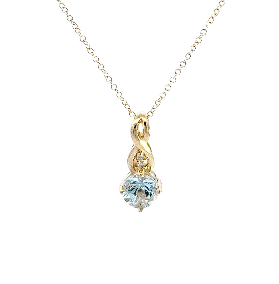 Gold necklace with a heart-shaped blue gemstone pendant on a white background