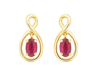 Gold earrings with red gemstones on a white background