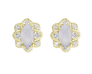 Pair of gold earrings with opal stones on a white background