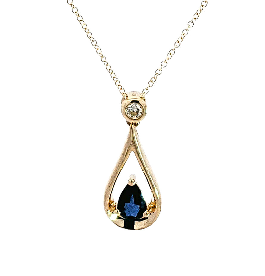 Gold teardrop-shaped pendant with a blue gemstone on a white background