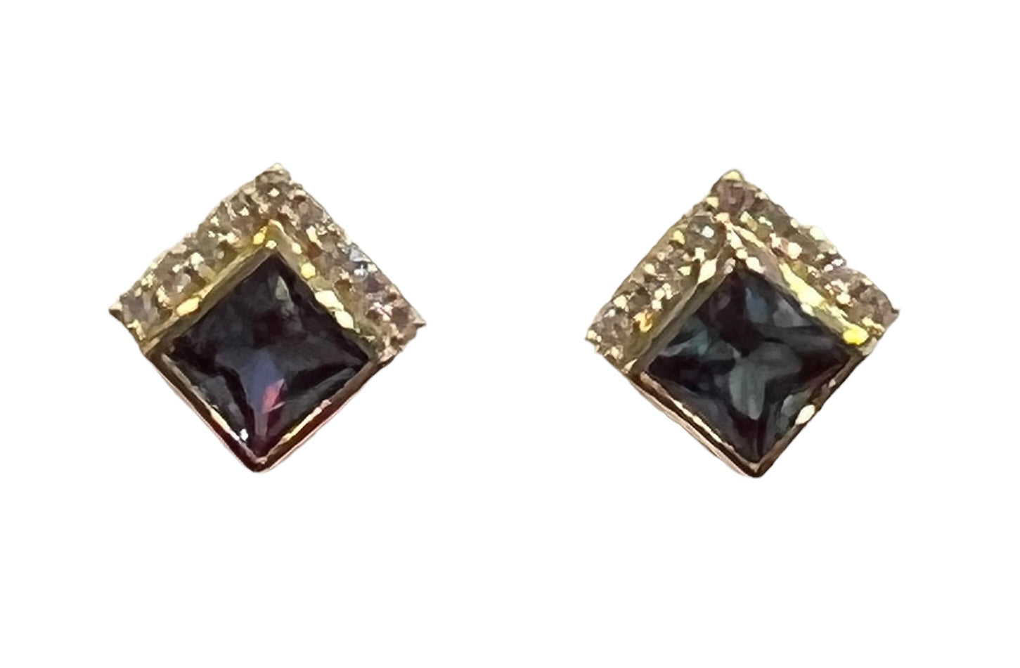 Pair of square-shaped earrings with black gemstones and gold accents on a white background