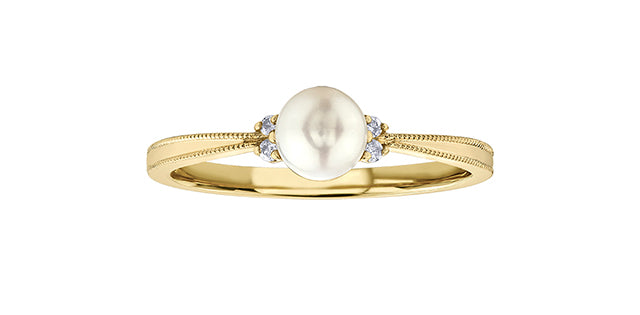 Gold ring with a pearl and small diamonds on a white background