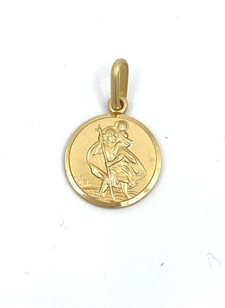 Gold pendant with a religious design on a white background