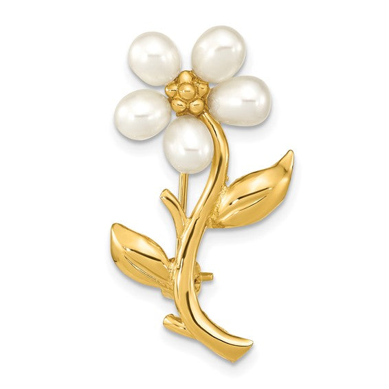 Gold and pearl flower brooch on a white background