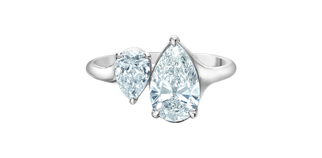 Silver ring with pear-shaped diamonds on a white background