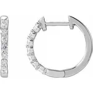 Silver hoop earrings with small diamonds on a white background