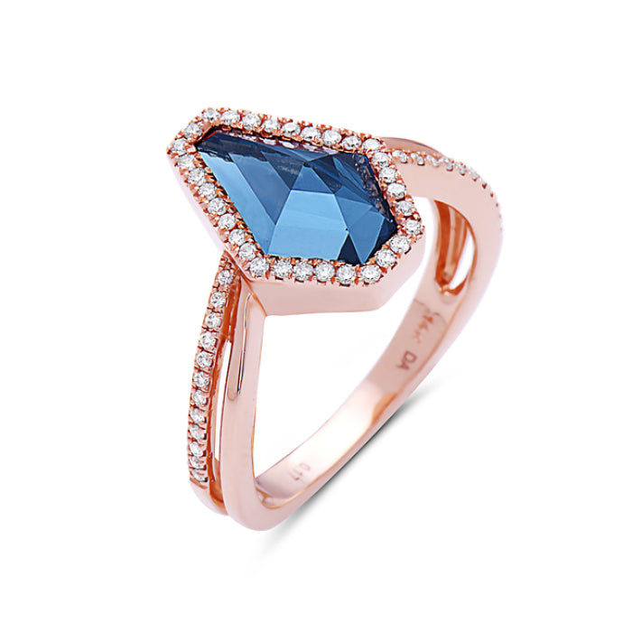 Rose gold ring with a blue gemstone and diamond accents on a white background