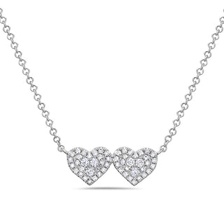 Necklace with two heart-shaped diamond pendants on a white background