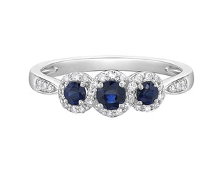 Silver ring with three blue gemstones on a white background