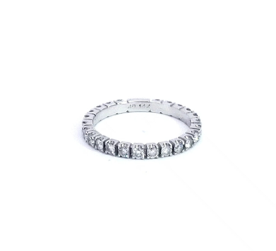 A 14K white gold diamond semi eternity ring with multiple diamonds set around the circumference.