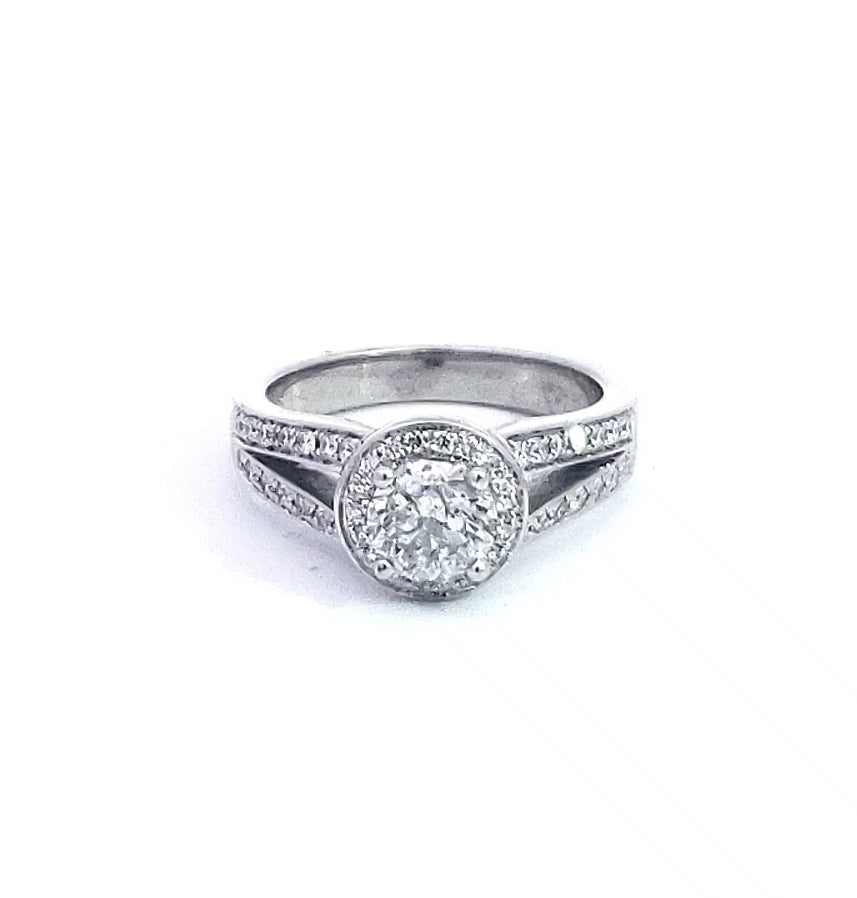 A 14K white gold diamond halo engagement ring with multiple smaller diamonds set around the band.