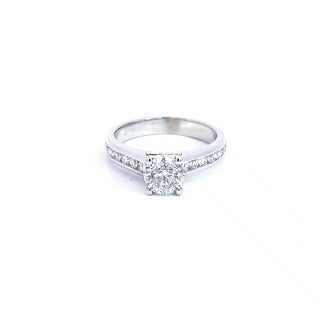 A 14K white gold engagement ring with a round brilliant cut diamond centerpiece, surrounded by smaller white diamonds set in a band.