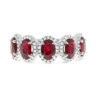Silver ring with red gemstones on a white background