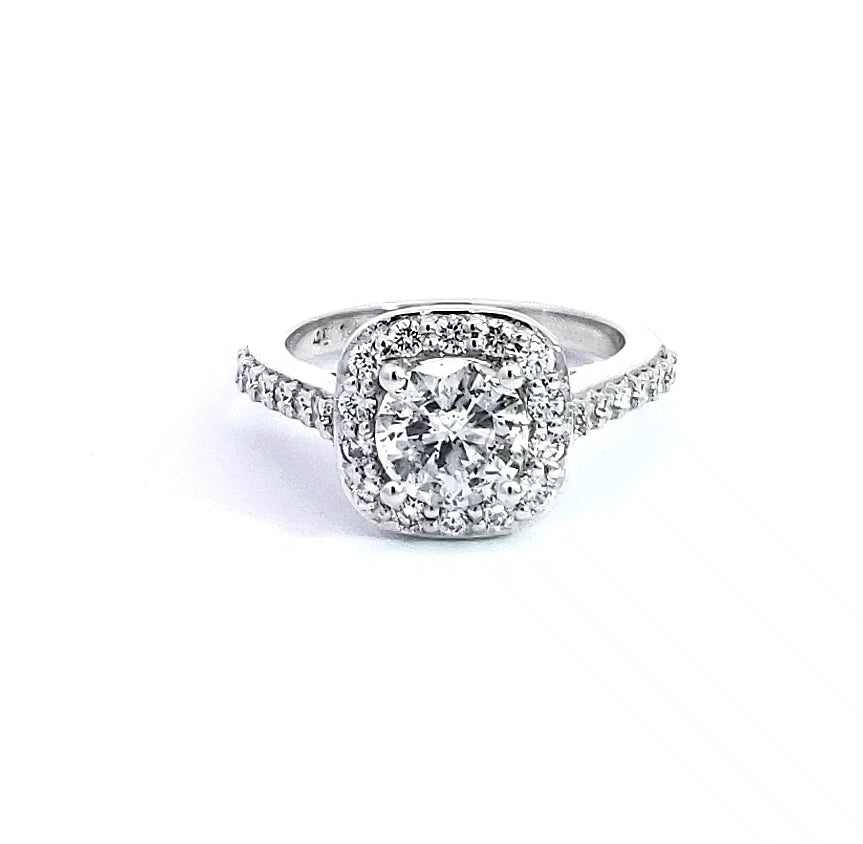 A 14K white gold diamond halo engagement ring with multiple smaller diamonds set around the band.