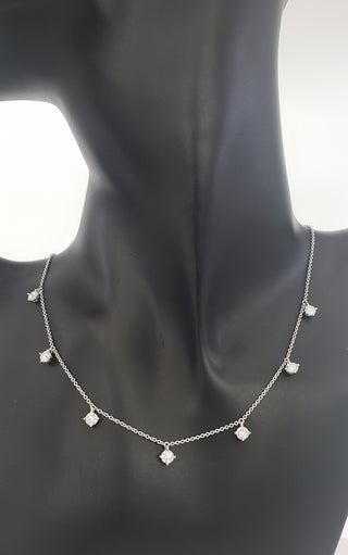 Silver necklace with diamond-shaped pendants on a mannequin