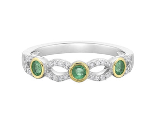 Silver ring with three green gemstones on a white background