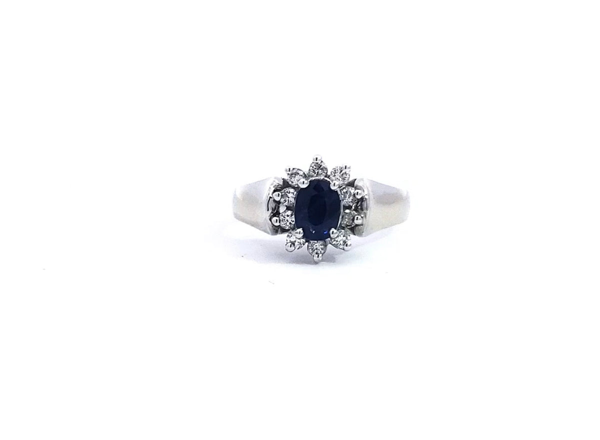 A 14K white gold sapphire and diamond ring with a clear, polished finish and a visible diamond band.