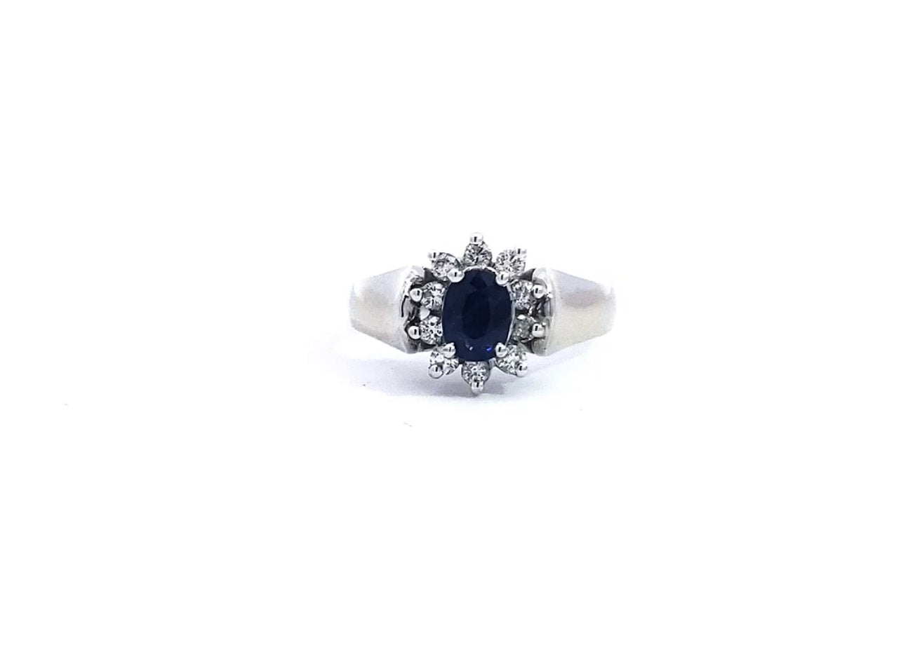 A 14K white gold sapphire and diamond ring with a clear, polished finish and a visible diamond band.