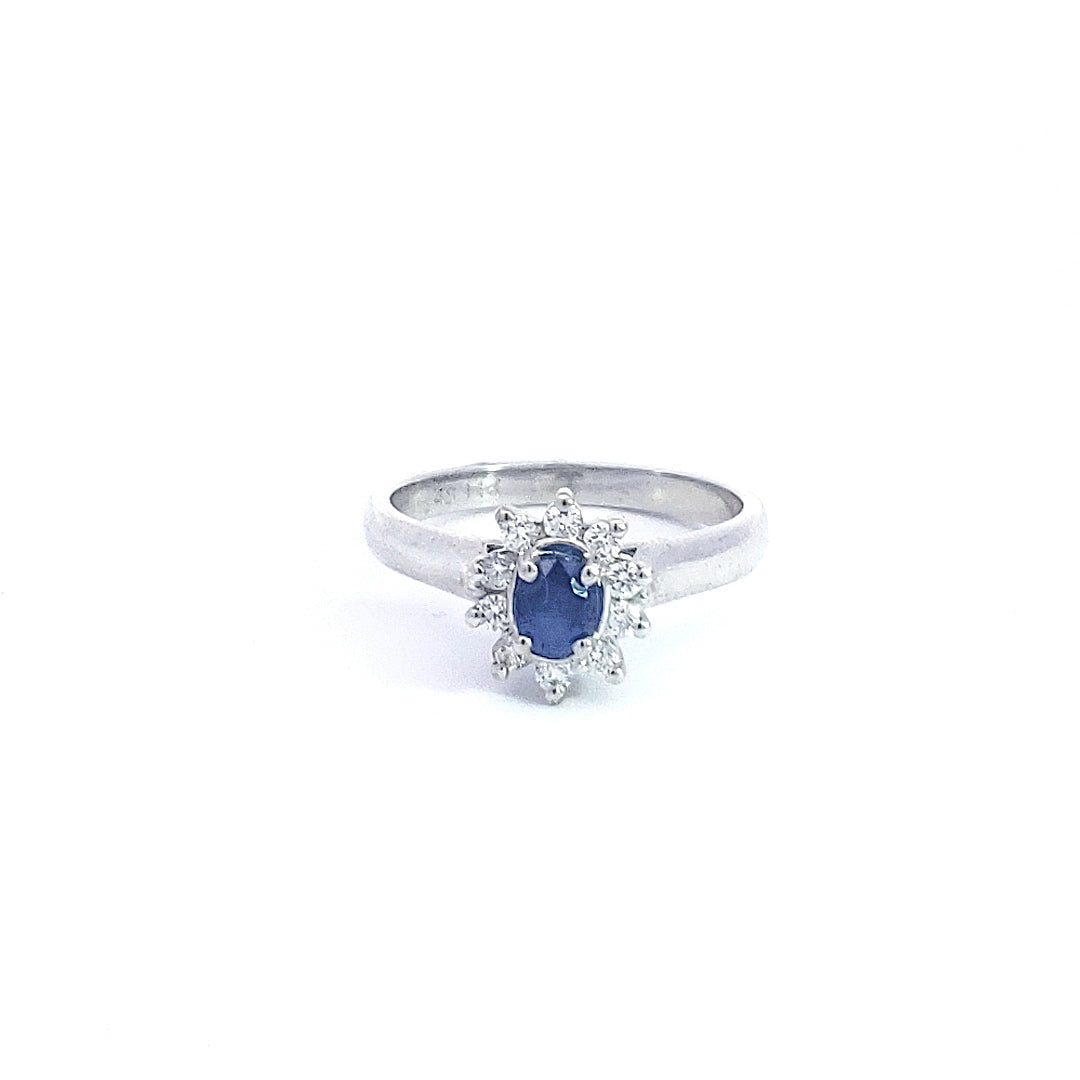 Silver ring with a blue gemstone on a white background
