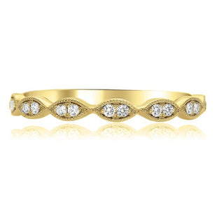 Gold ring with embedded diamonds on a white background