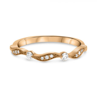 Rose gold ring with diamonds on a white background