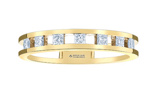 Gold ring with diamond accents on a white background