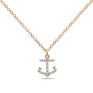 Gold anchor-shaped necklace with diamonds on a white background