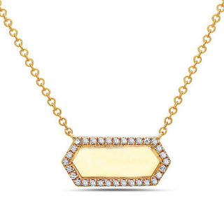 Gold necklace with a hexagonal pendant and diamonds on a white background