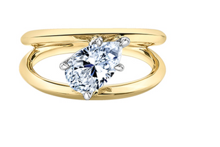 Gold ring with a pear-shaped diamond on a white background