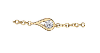 Gold bracelet with a diamond on a white background