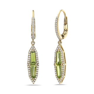 Gold earrings with green gemstones on a white background
