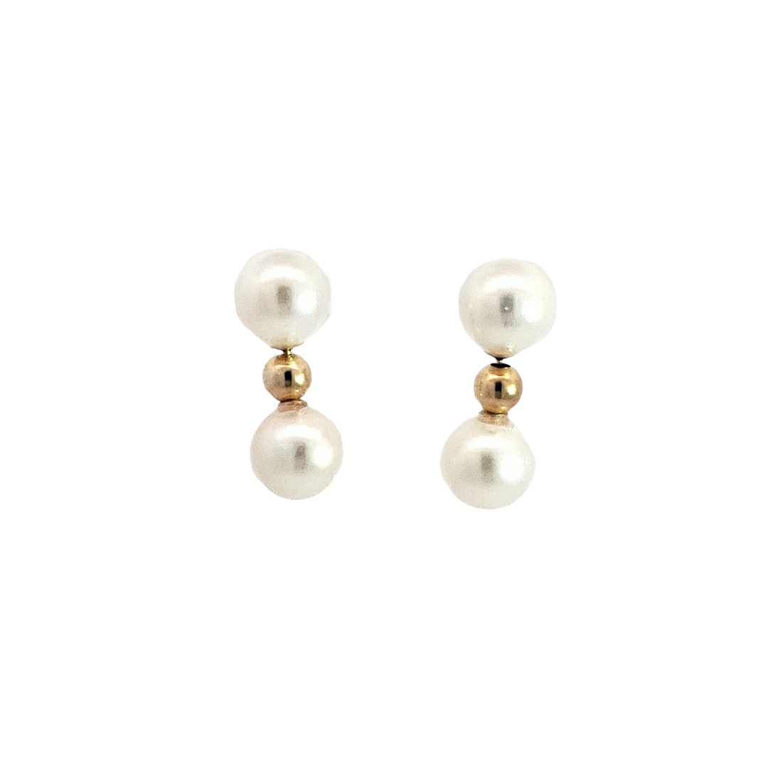 Pair of pearl earrings with gold accents on a white background