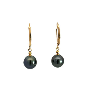 Pair of black pearl earrings with gold hooks on a white background