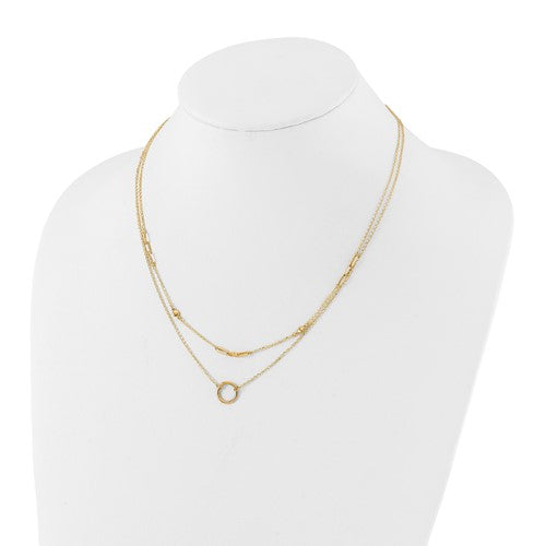 Gold necklace on a mannequin with a white background