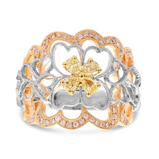 Gold and silver ring with a butterfly design on a white background