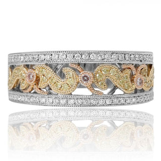 Decorative ring with intricate design and gemstones on a white background
