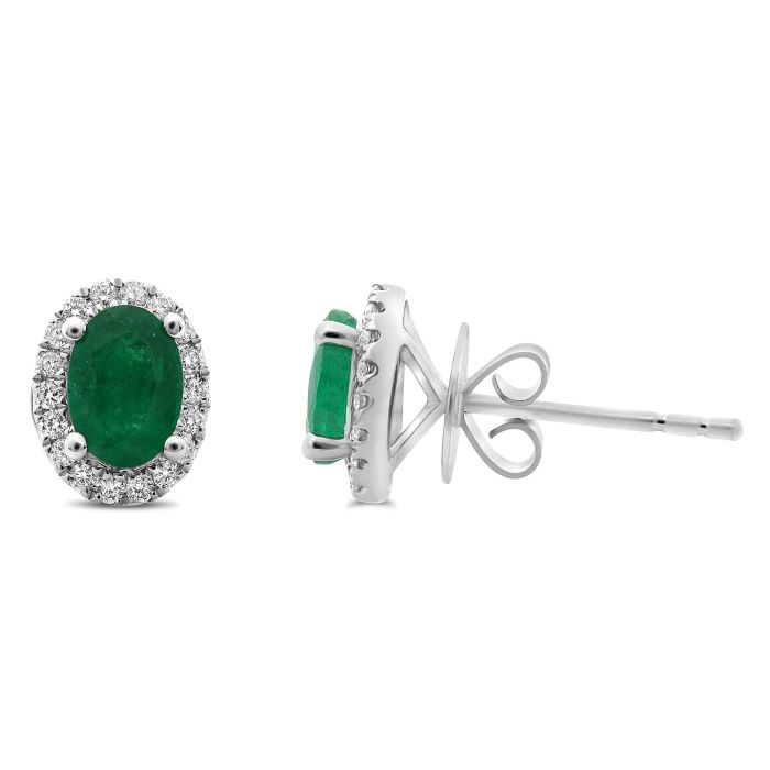 Pair of emerald and diamond earrings on a white background