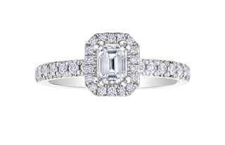 Diamond ring with a central emerald-cut diamond and smaller diamonds on a white background