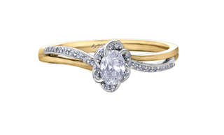 Gold and silver ring with a diamond on a white background