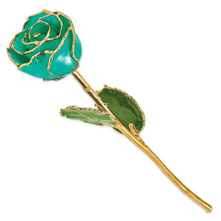 Green rose-shaped brooch with gold accents on a white background