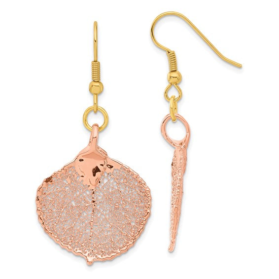 Gold and rose gold earrings on a white background